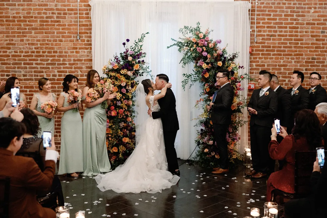 Couple kissing before their wedding party