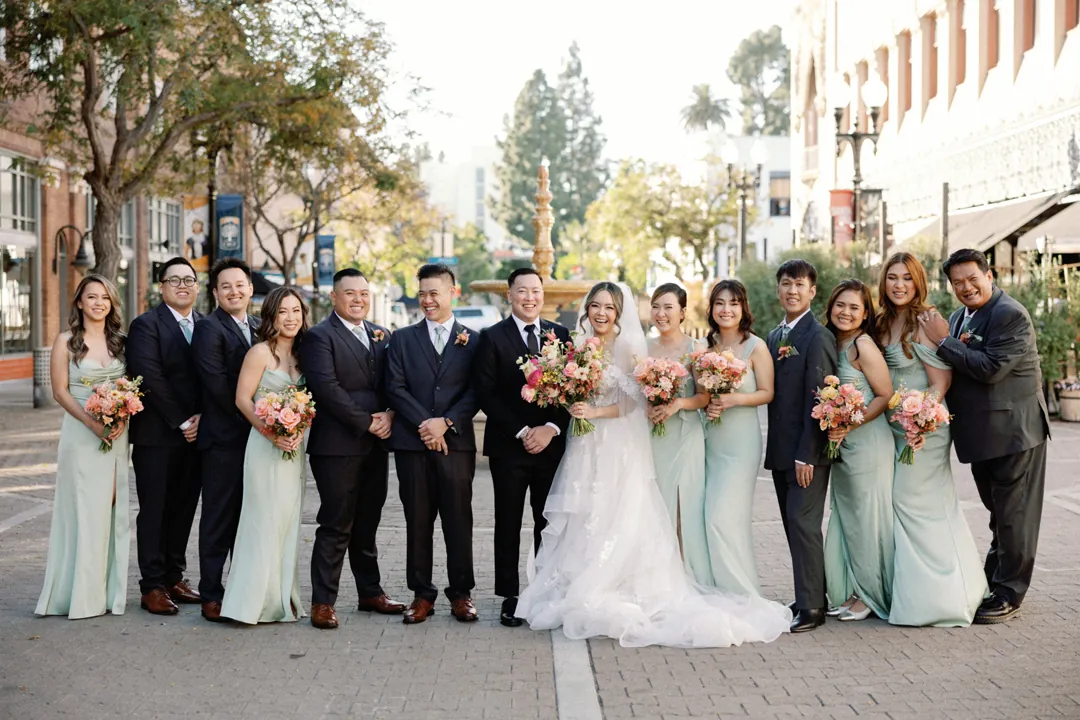 Wedding party posing together on a city street