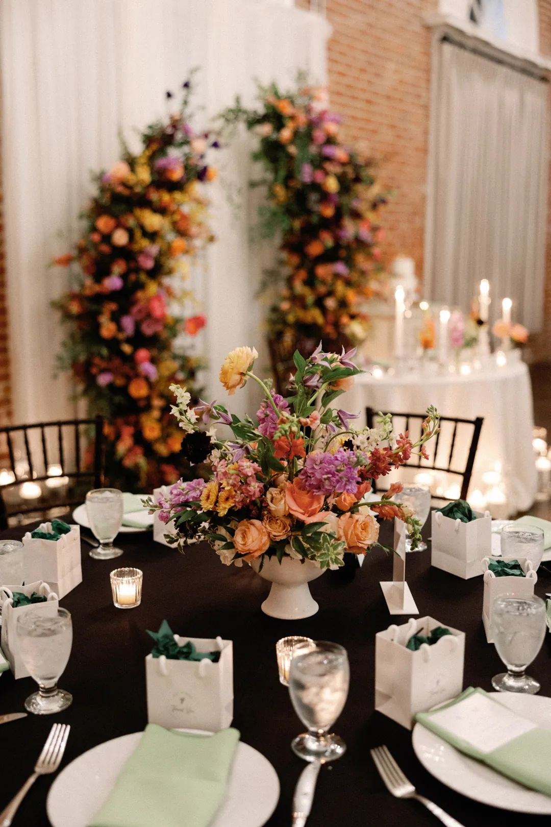 Dinner place settings with green napkins and glassware