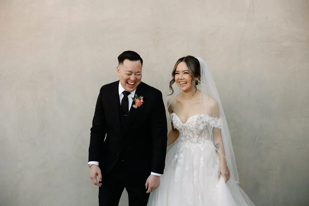 Couple laughing together on an outdoor terrace