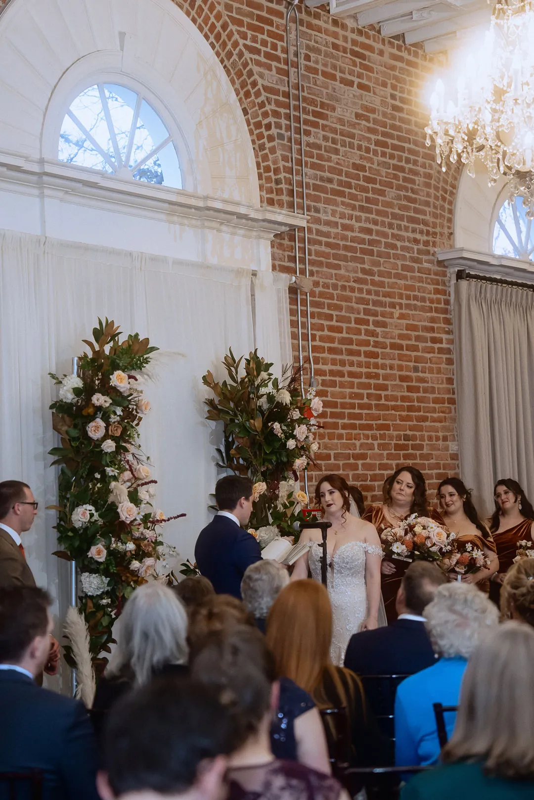 Guests watching a wedding ceremony in a ballroom