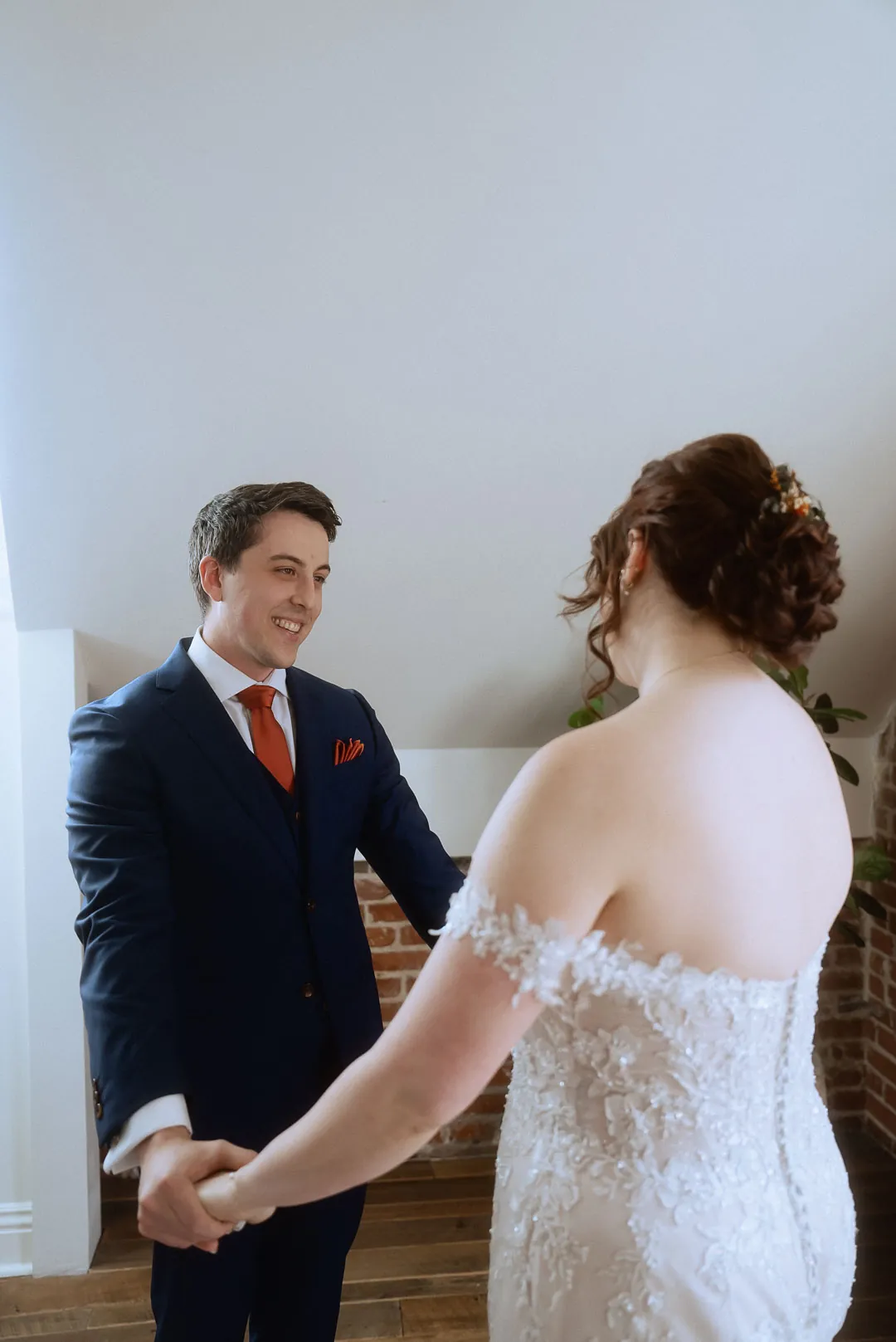 Couple holding hands and smiling in a loft