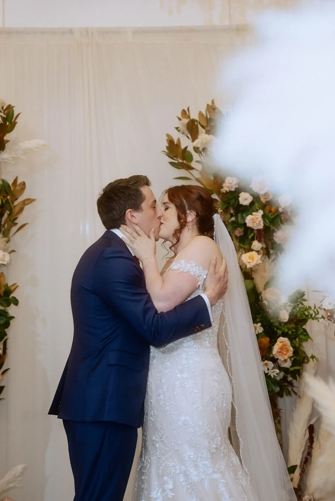 Couple kissing during their wedding ceremony