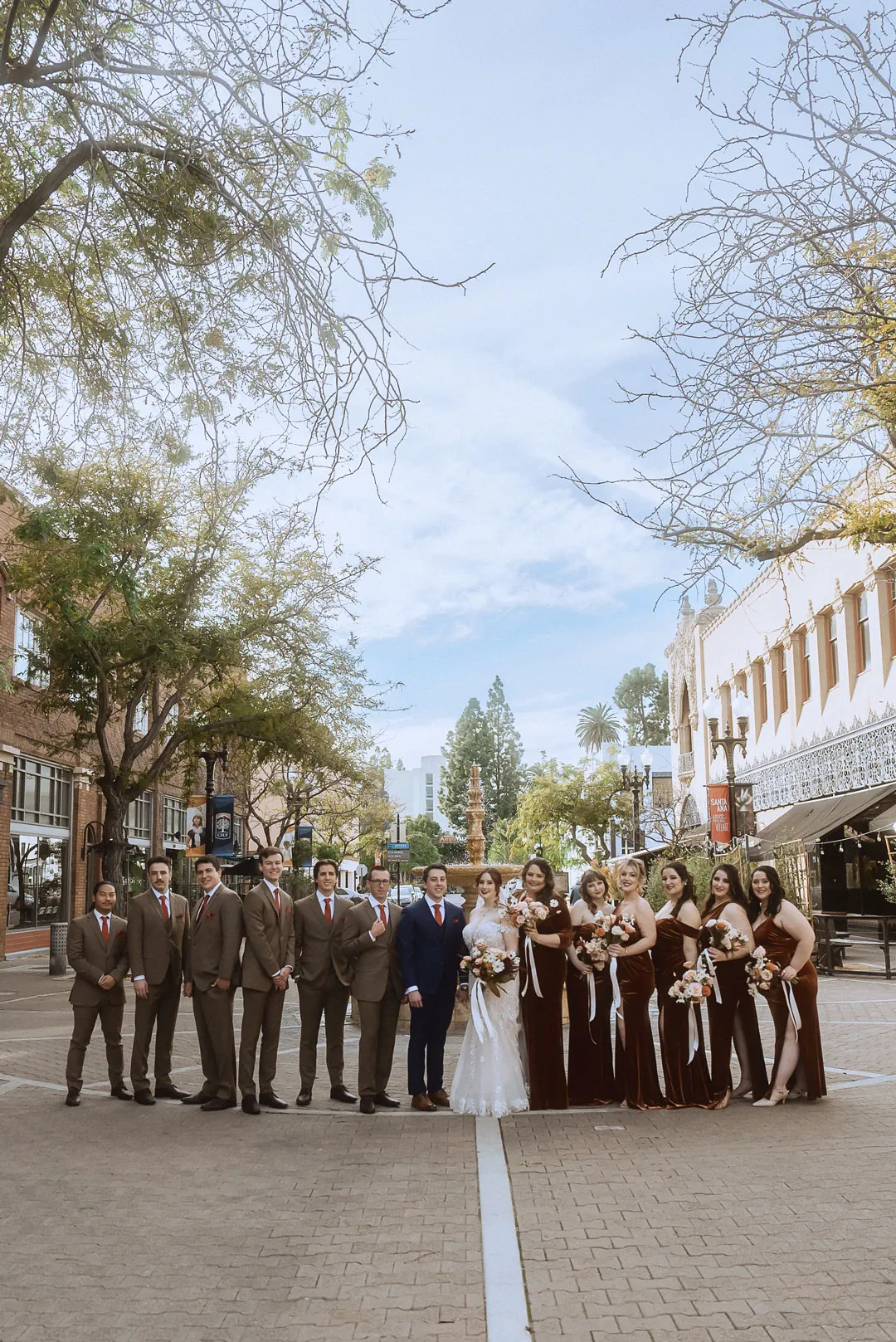 Wedding party posing together on a city street