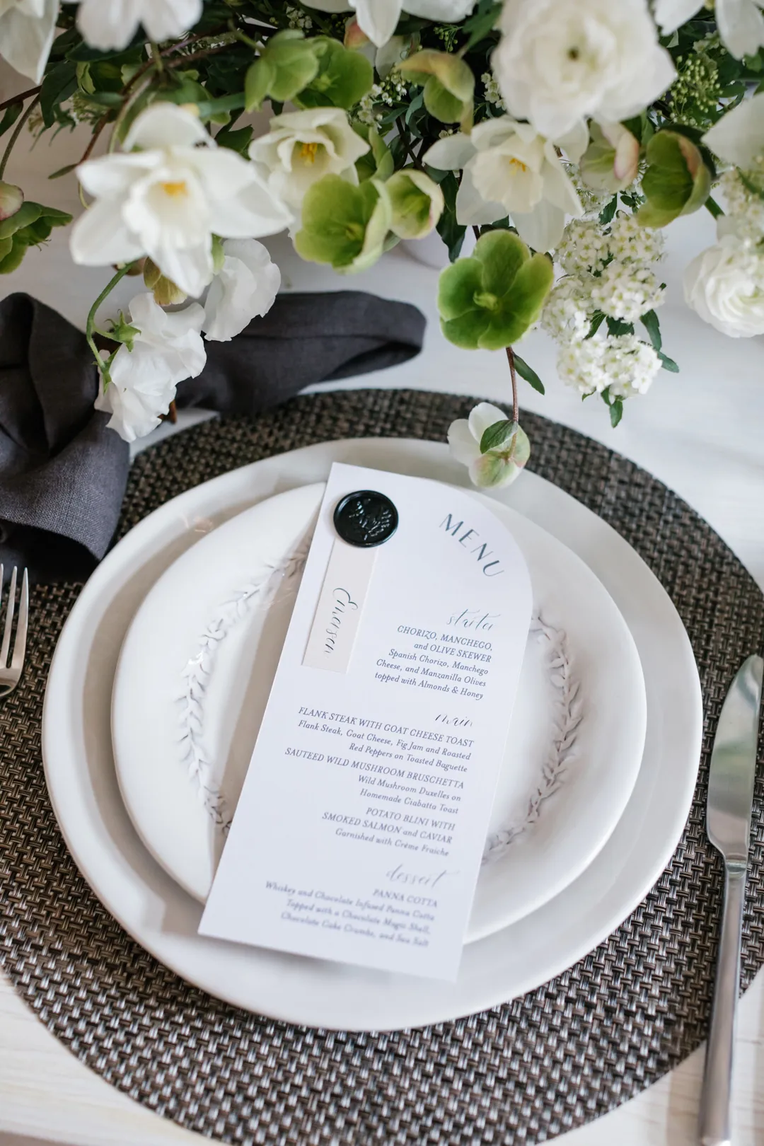 Printed reception menu on stacked white plates