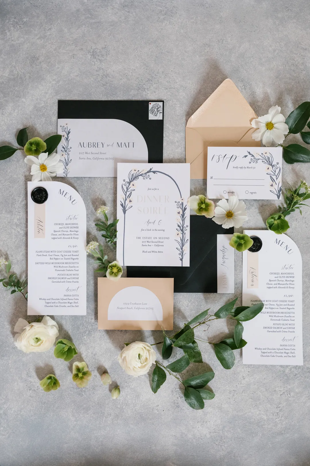 Wedding stationery arranged with white flowers
