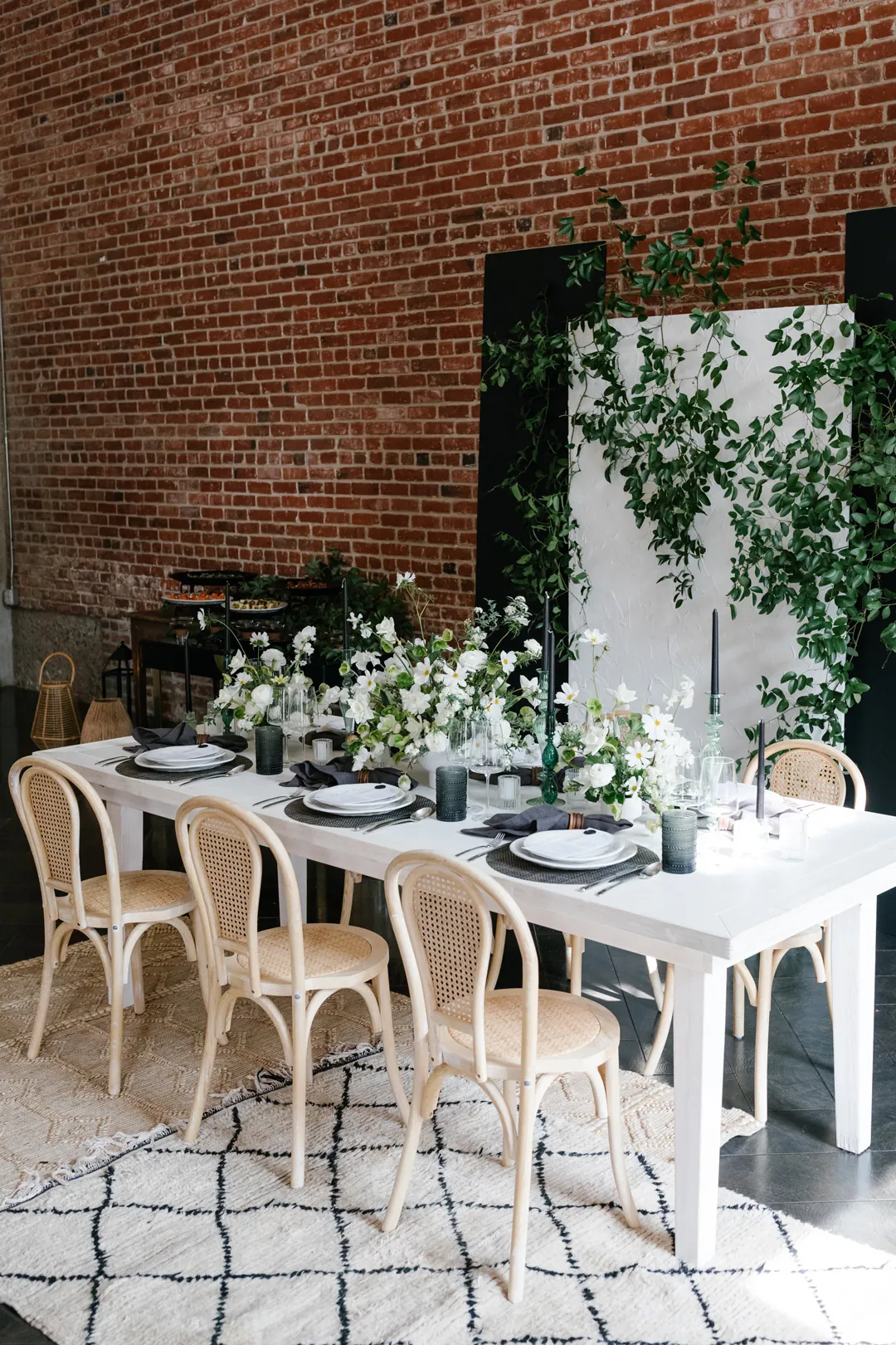 Dining table set beside a brick wall