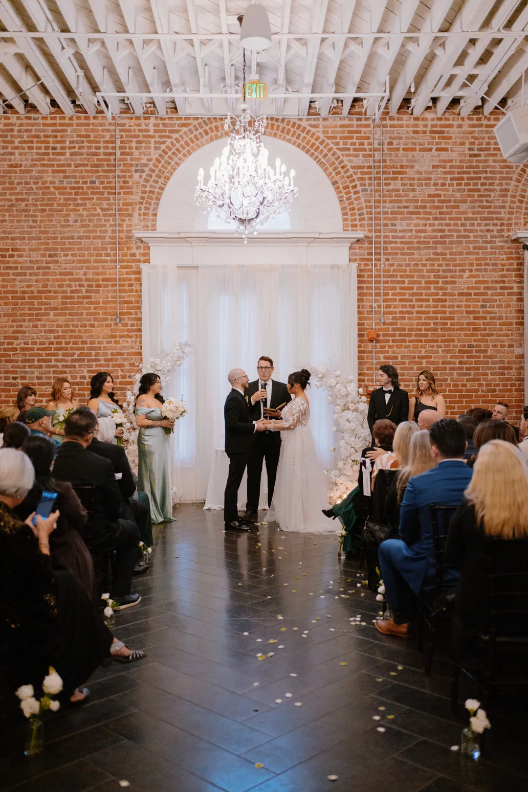 Wedding guests seated along the center ceremony aisle