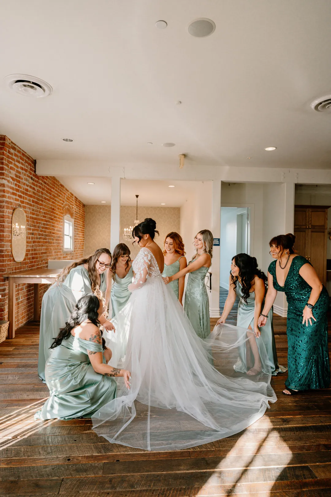 Bride and bridesmaids celebrating together in a sunlit room