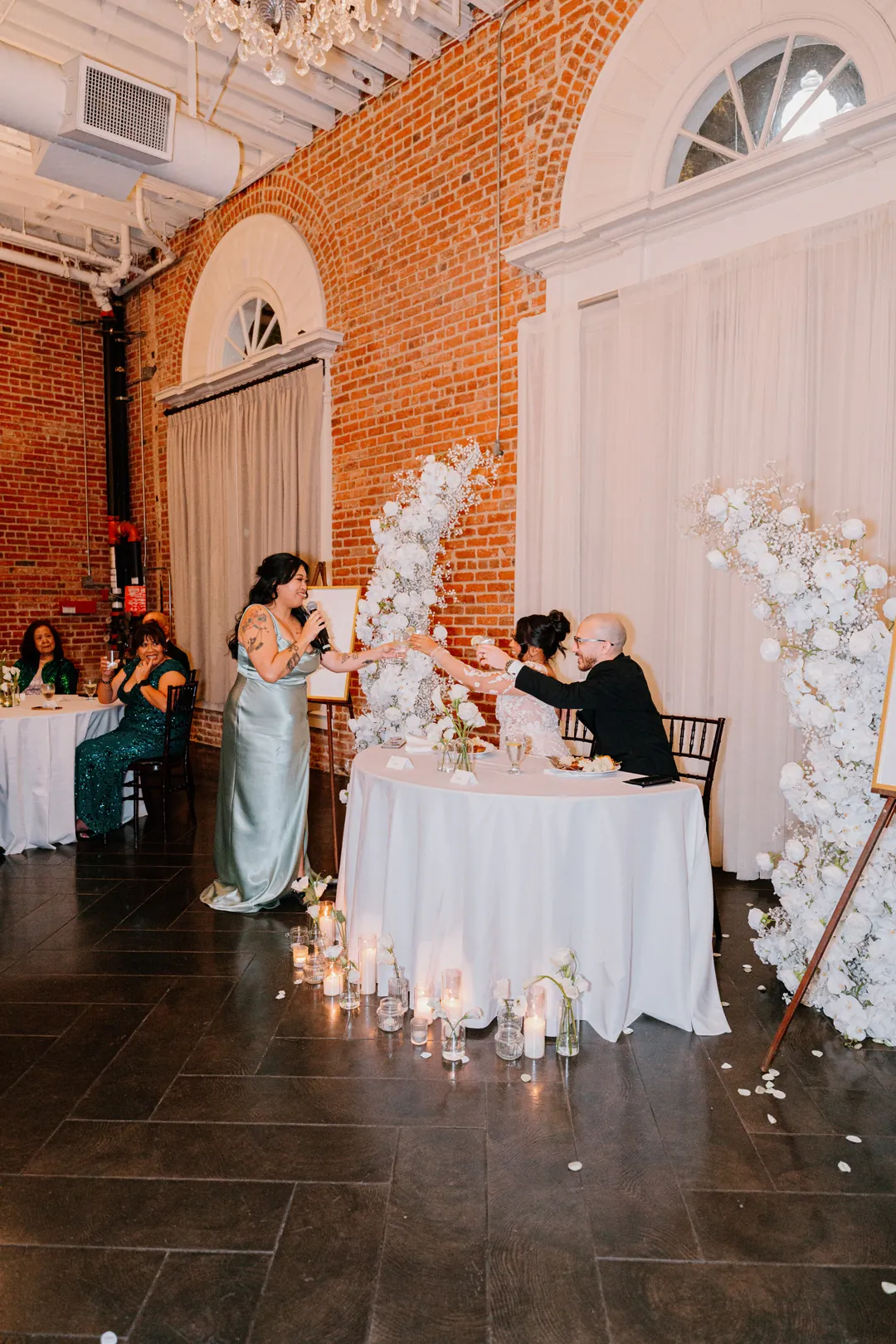 Guest speaking beside the couple's round sweetheart table