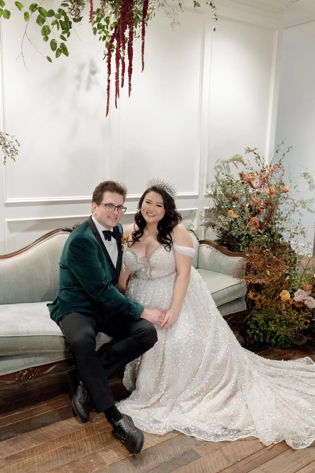 Couple seated together among colorful floral arrangements