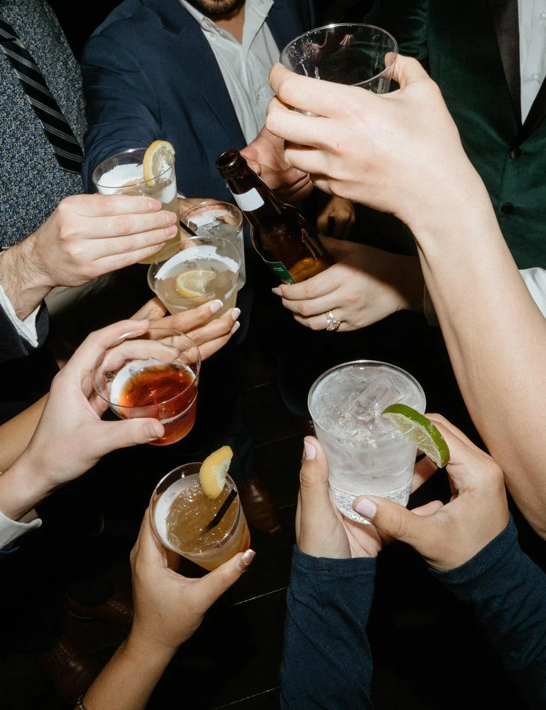 Guests raising small cocktail glasses together