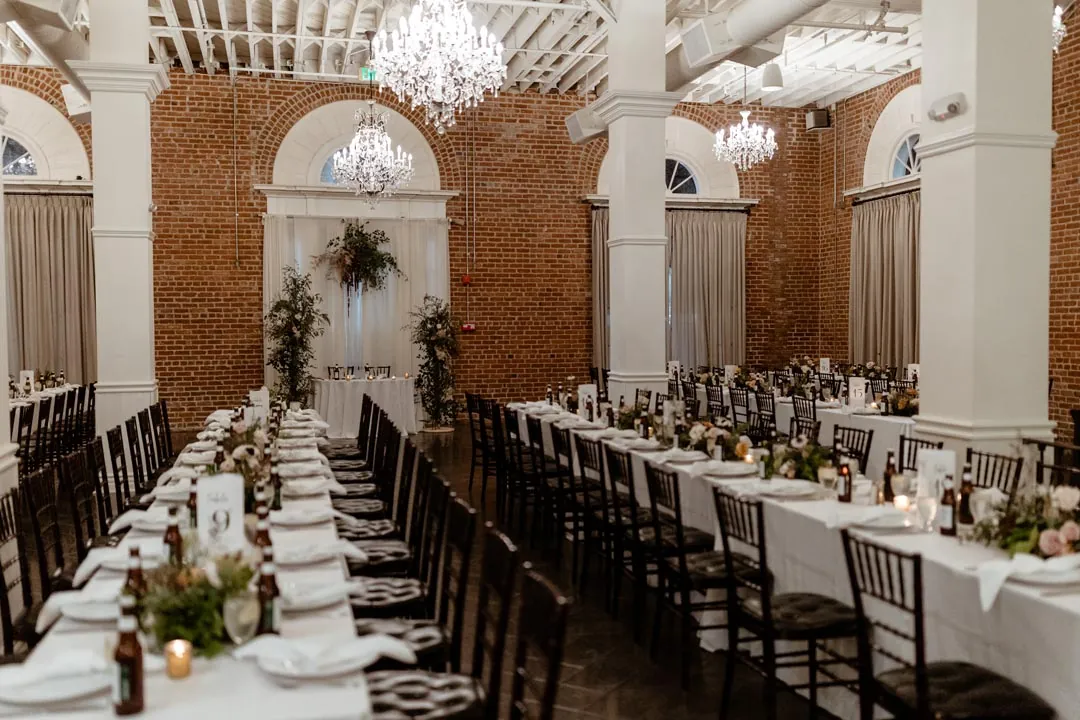 Long reception tables framing a center aisle