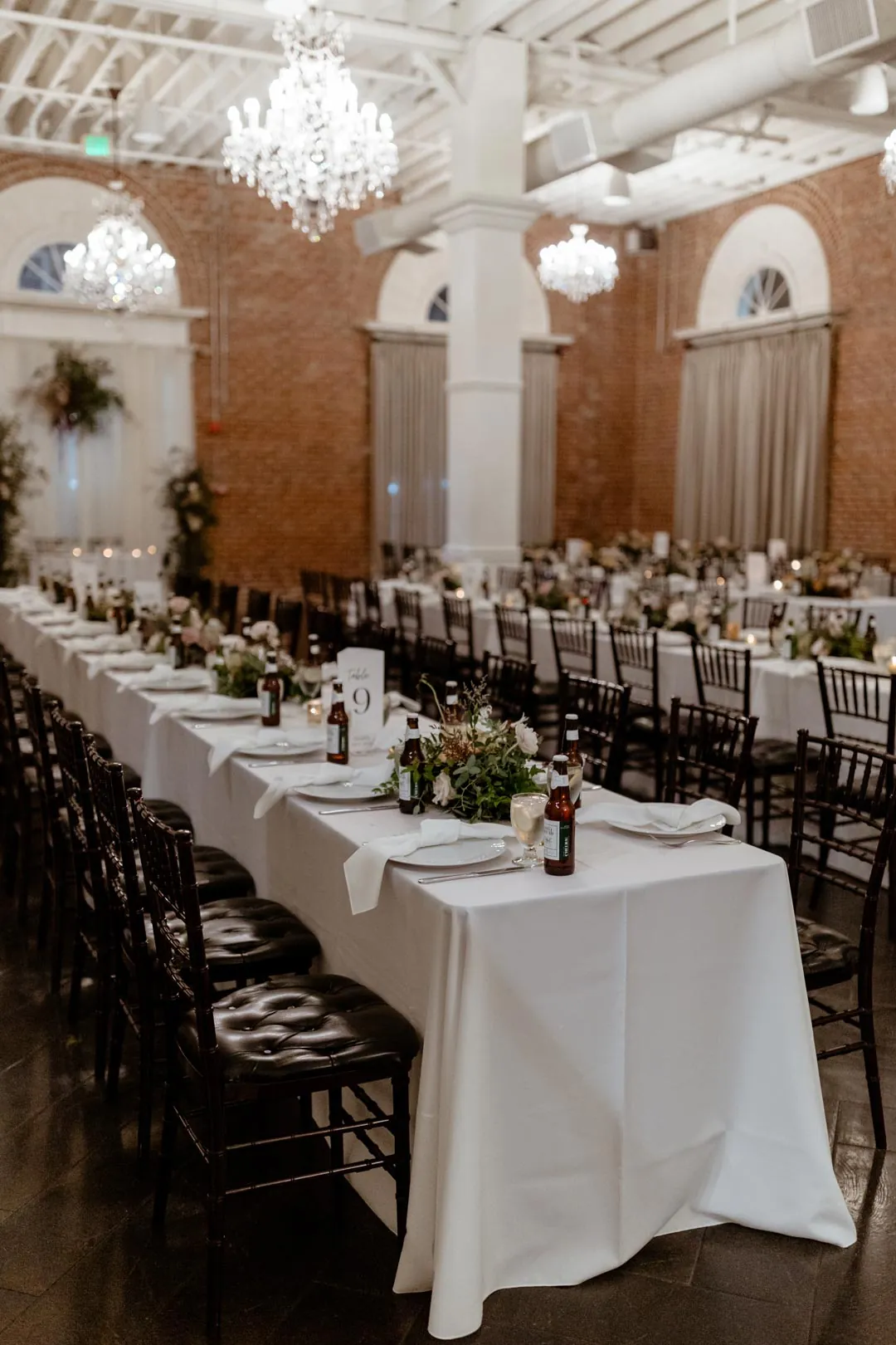 Floral centerpieces lining a long reception table