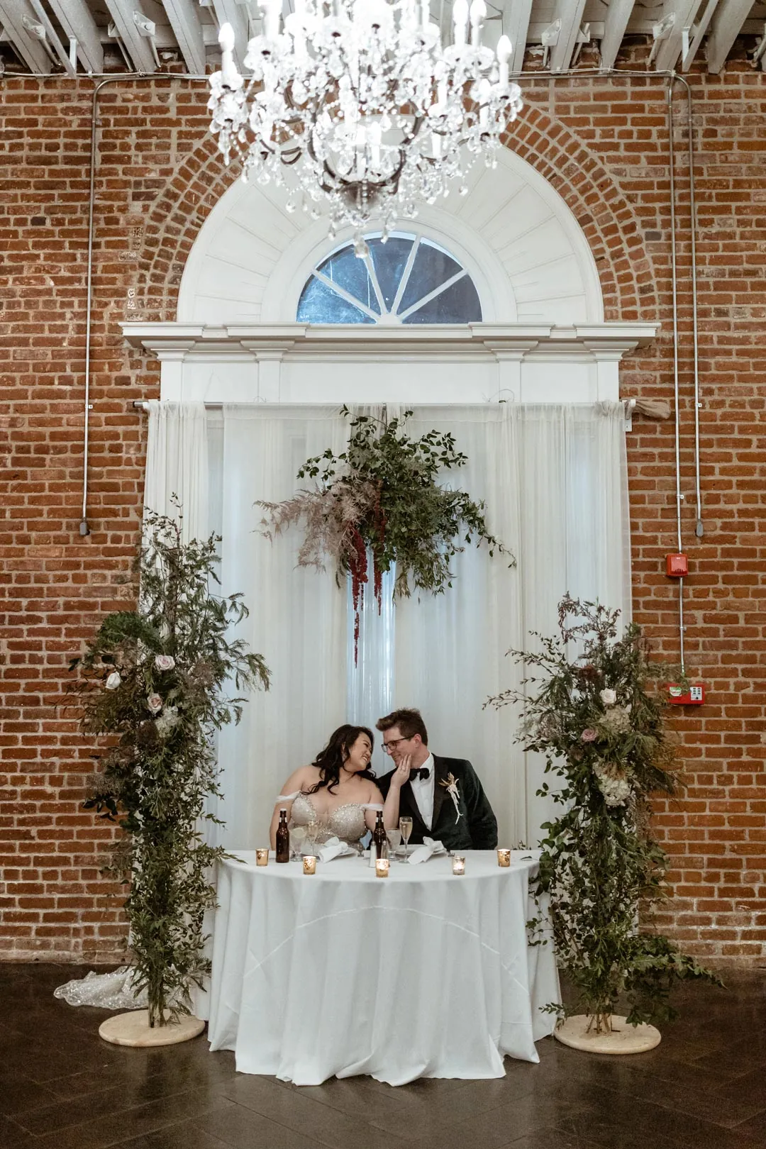Couple seated at their round sweetheart table