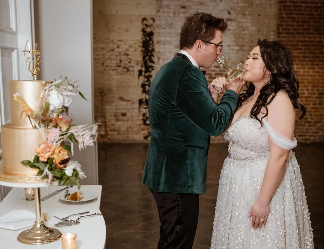 Groom feeding wedding cake to the bride