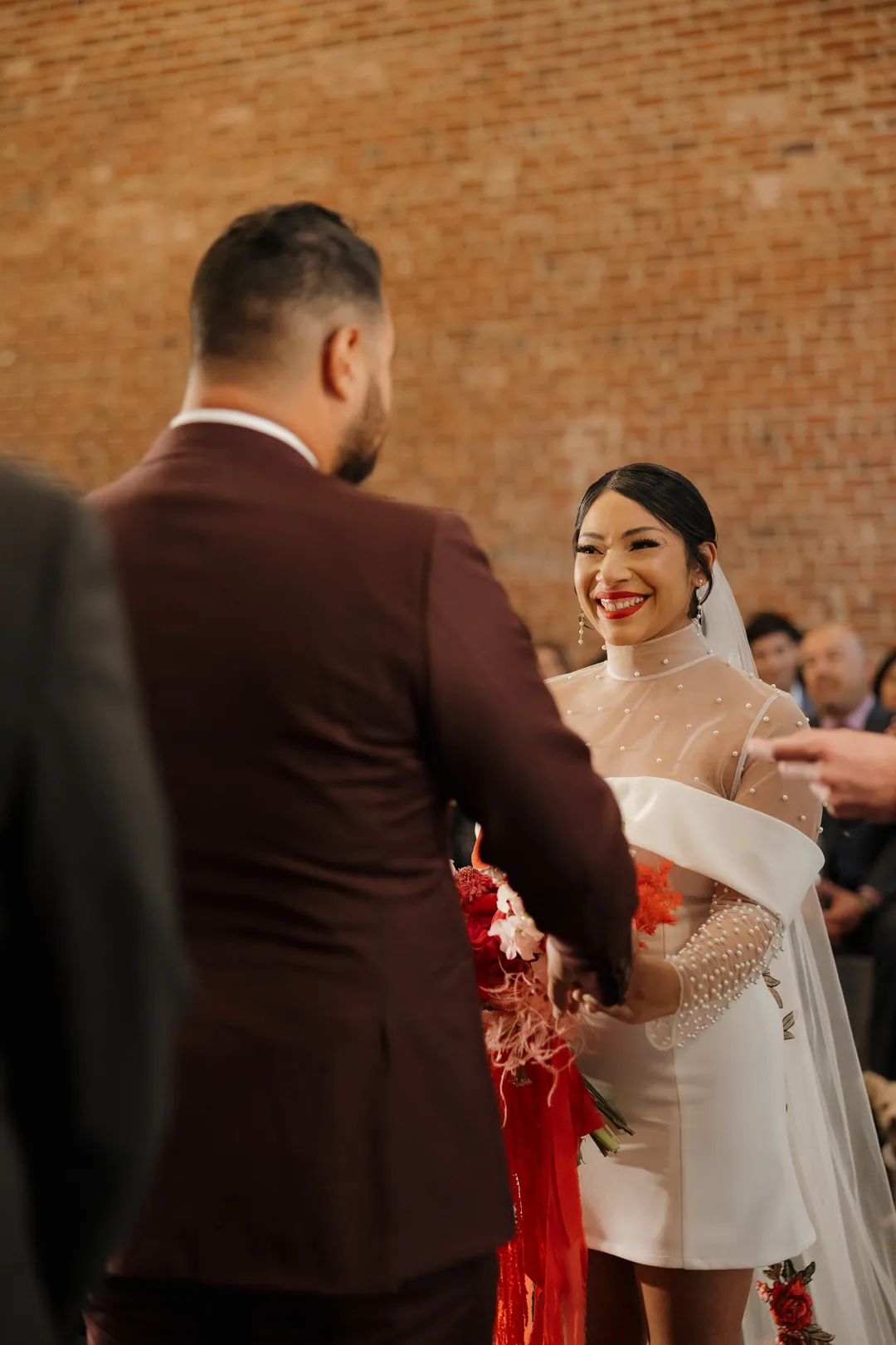 Bride smiles at the groom during their ceremony.