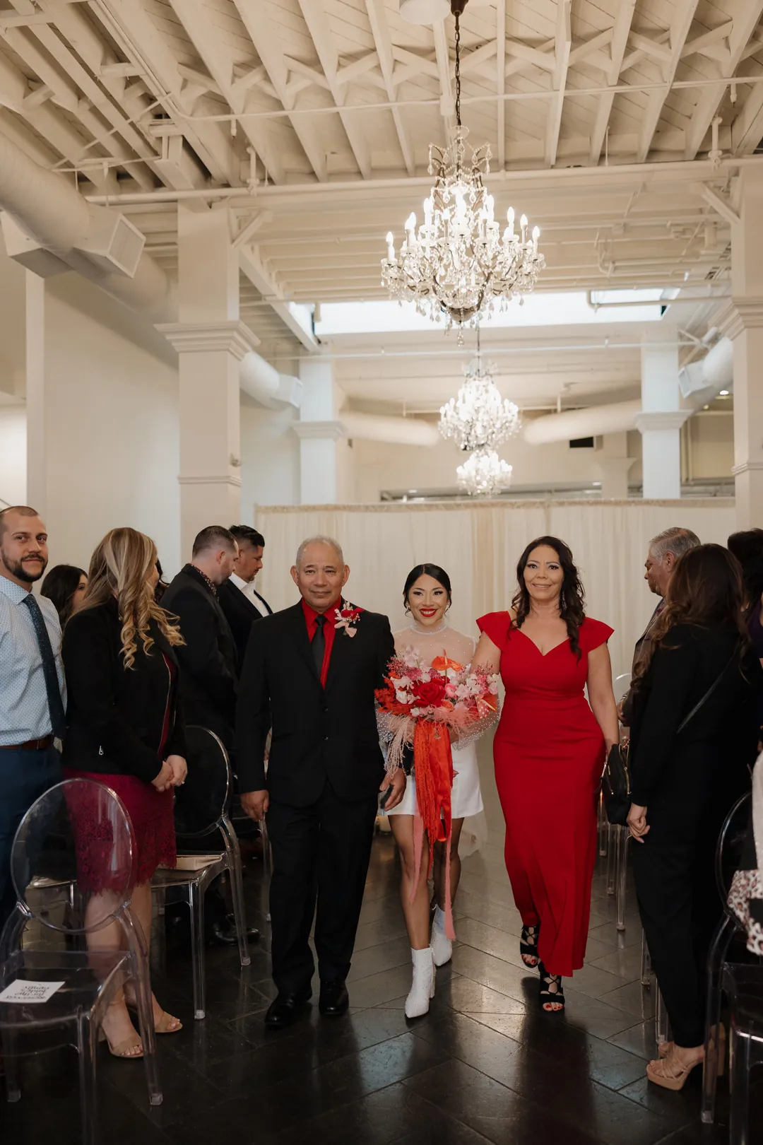 Bride enters the ceremony beside formally dressed guests.