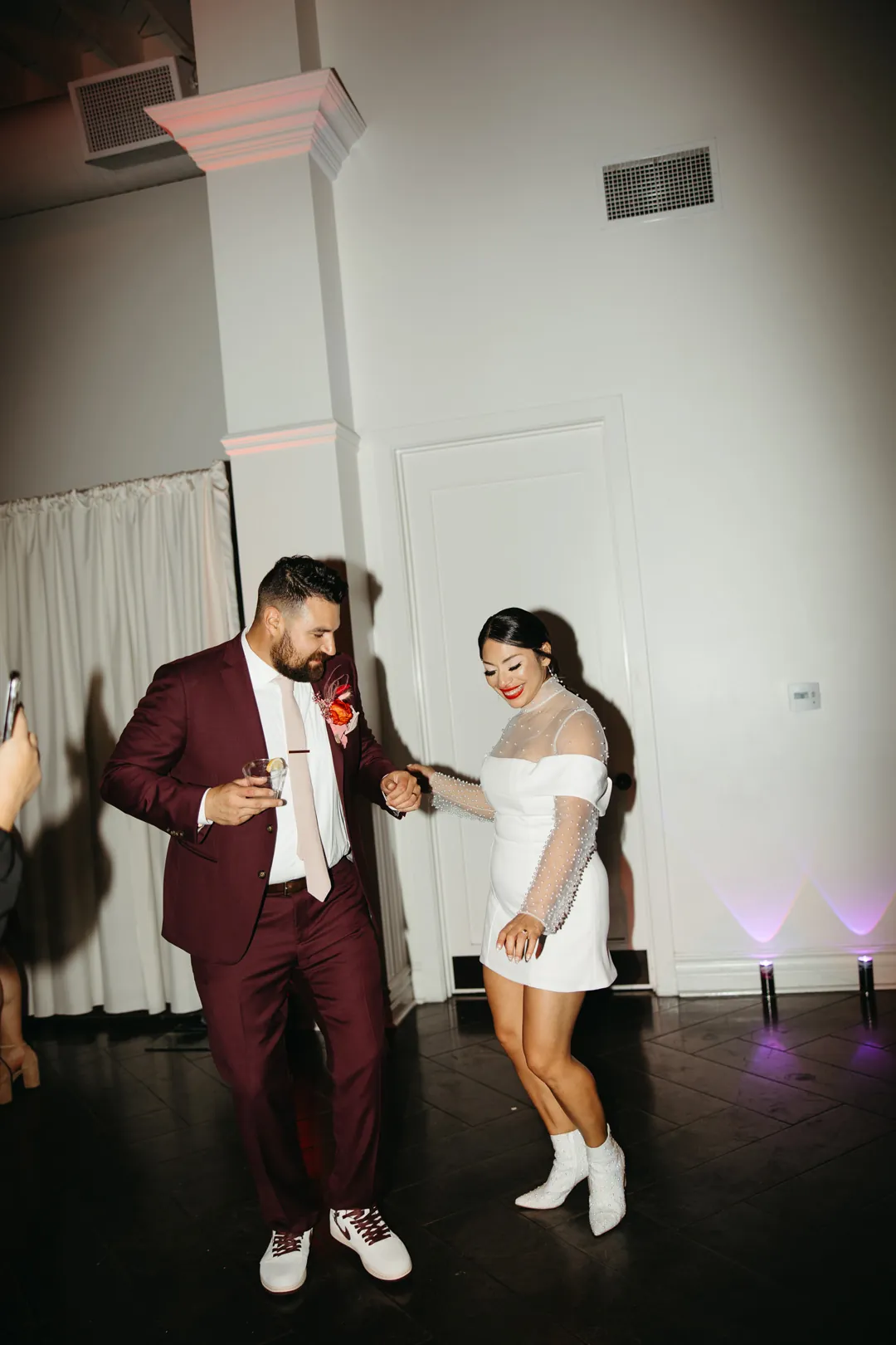 Couple dance together in a loft room.