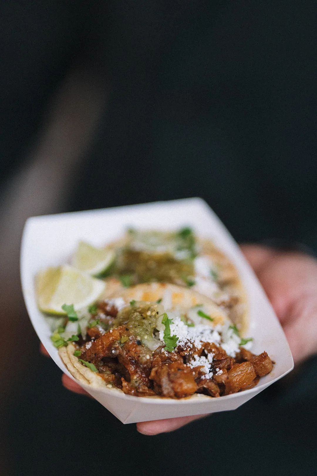 Guest holding a prepared dish in a small tray