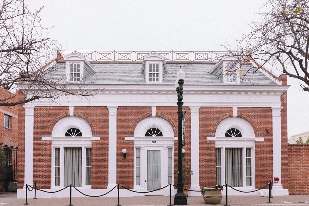 Brick facade of Estate on Second beneath bare trees