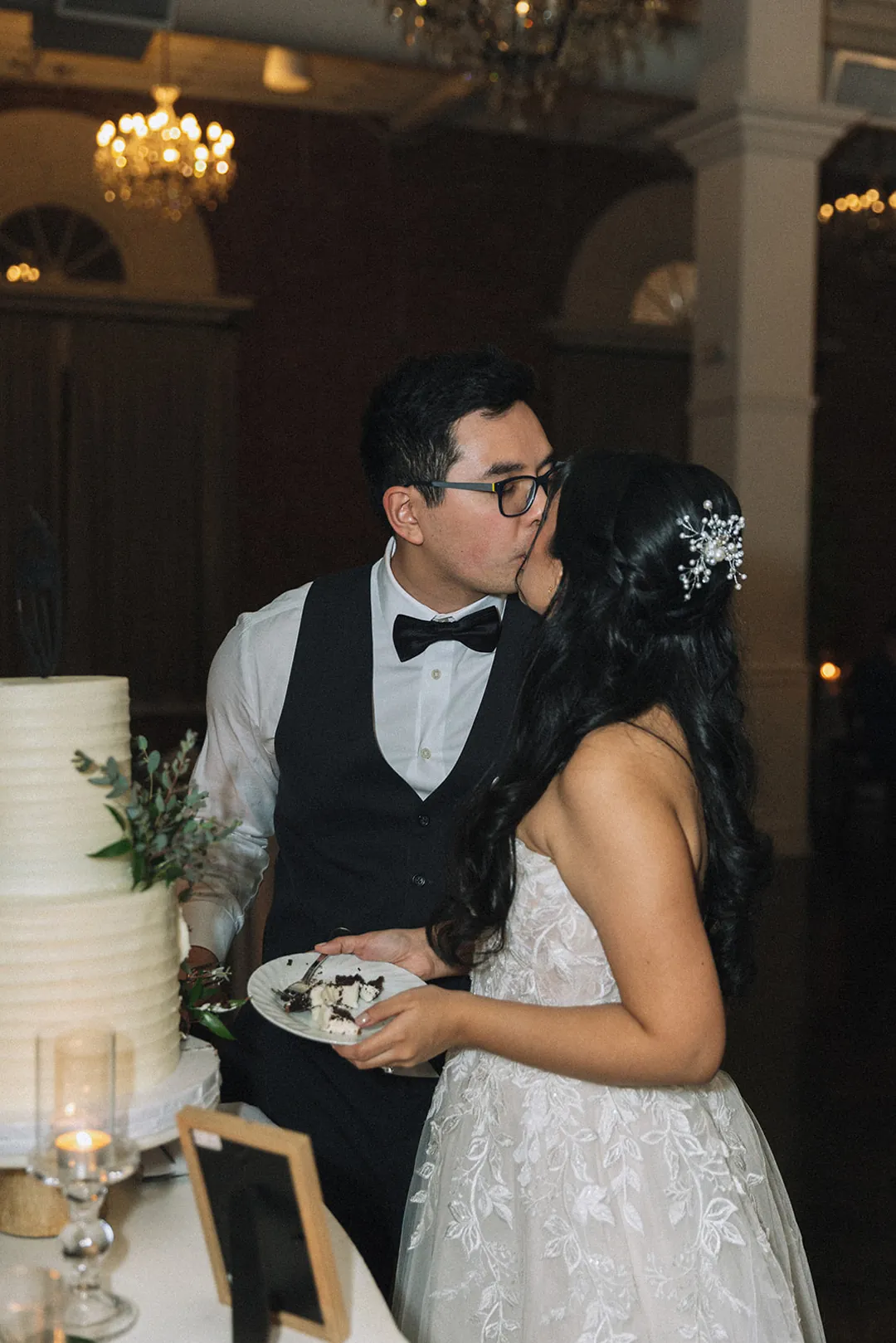 Bride and groom sharing cake together