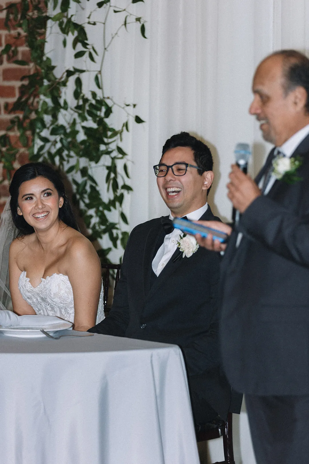 Guest speaking beside the sweetheart table
