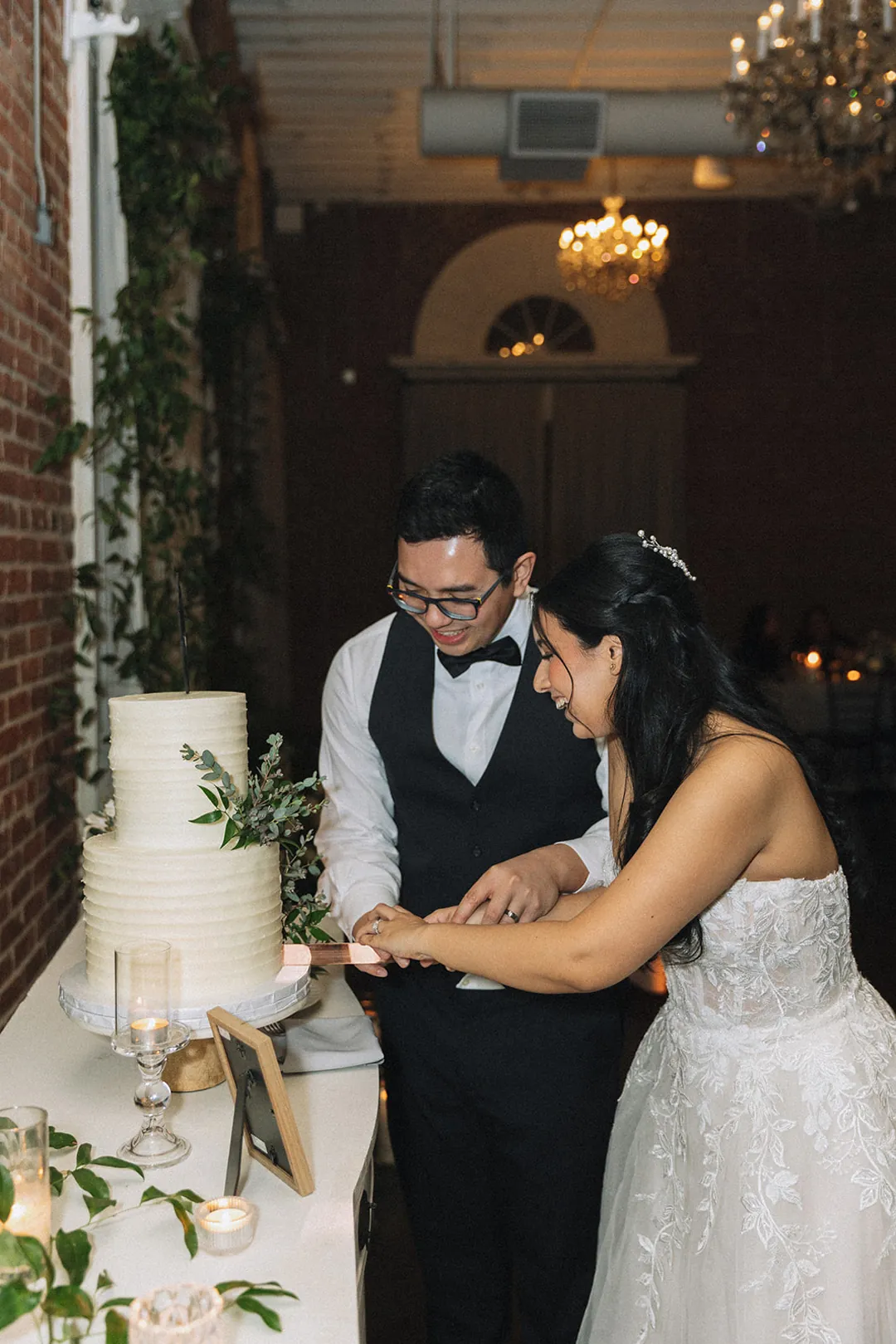 Newlyweds cutting their wedding cake
