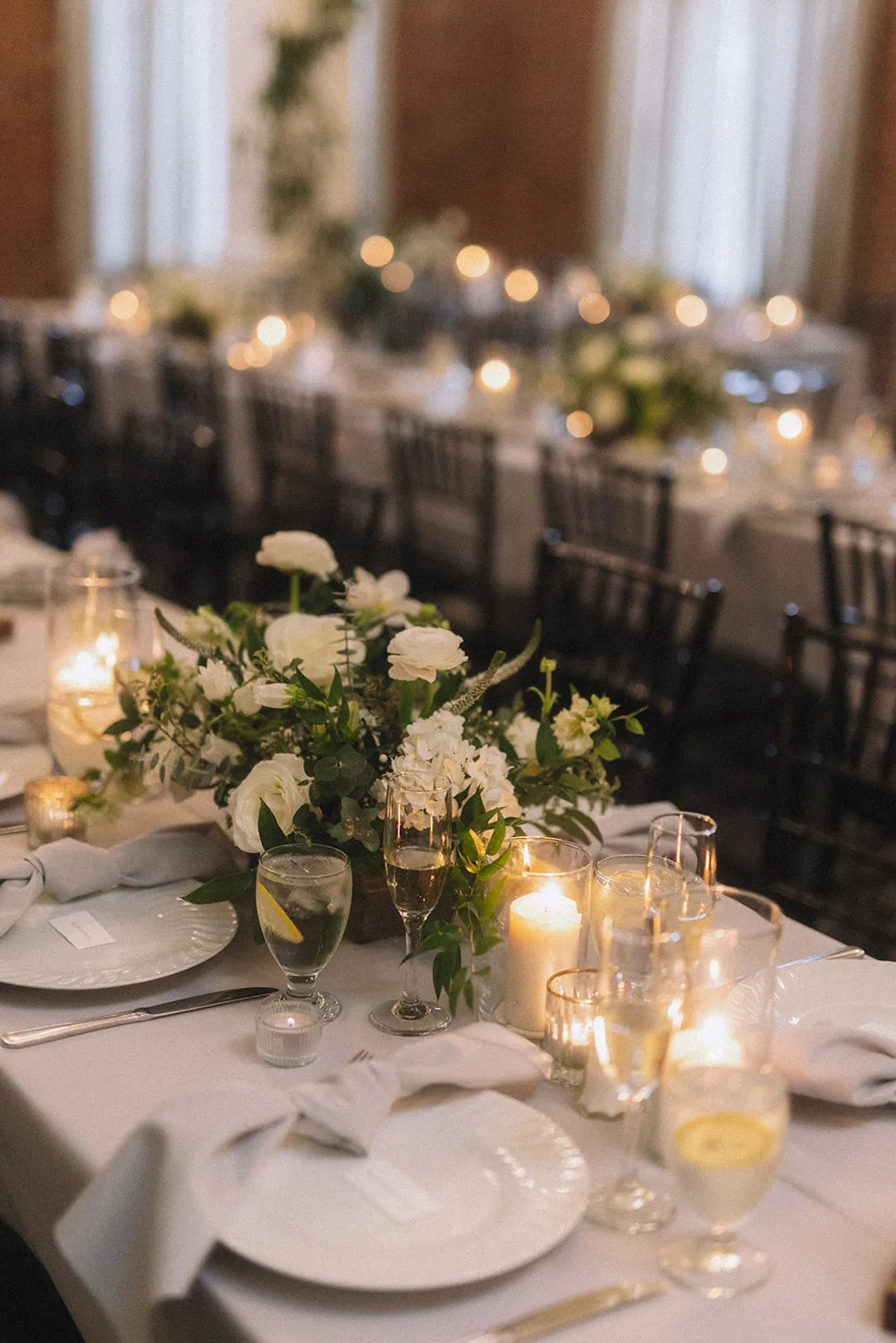 Reception place setting with white flowers and candles