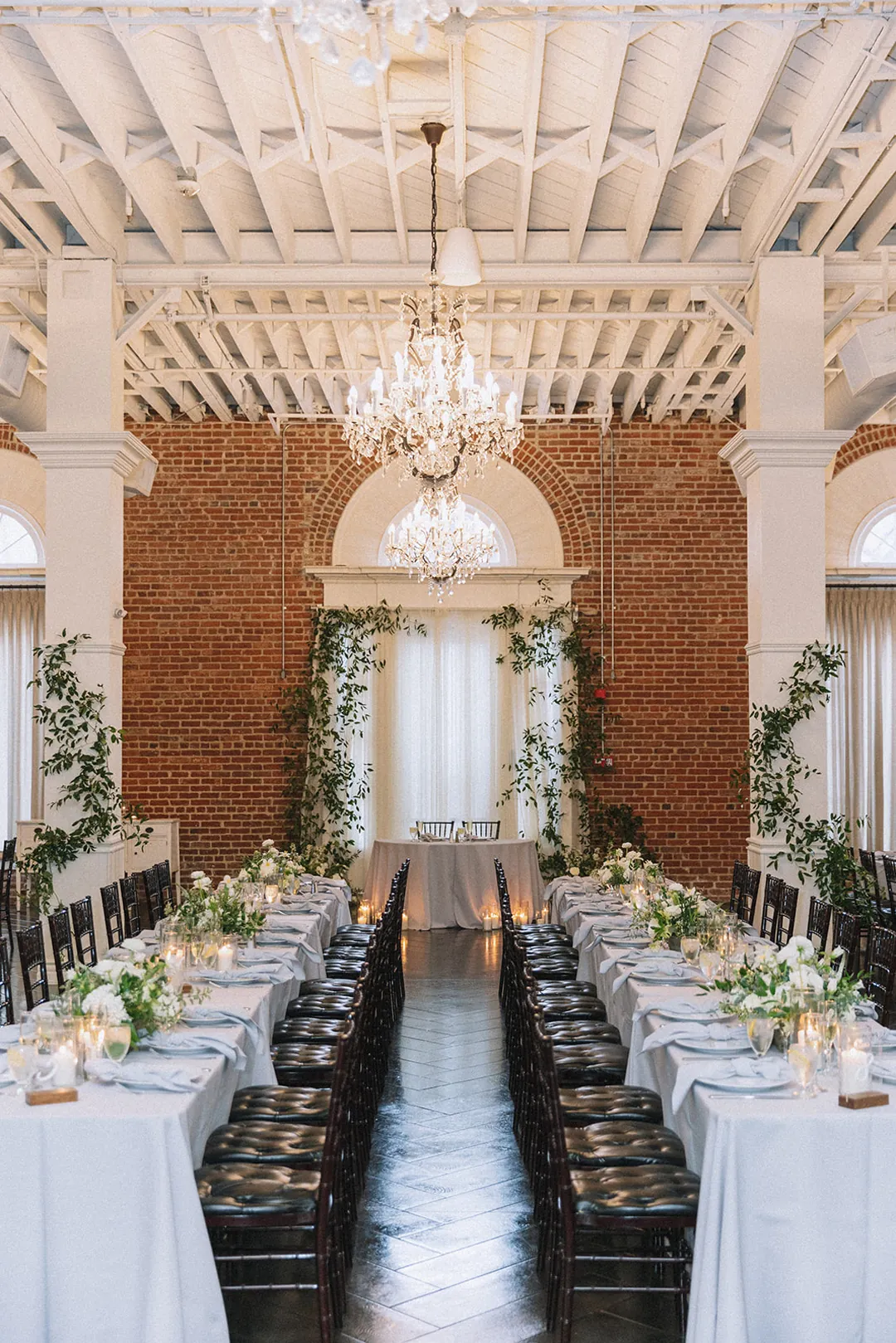 Long reception tables through the bright ballroom