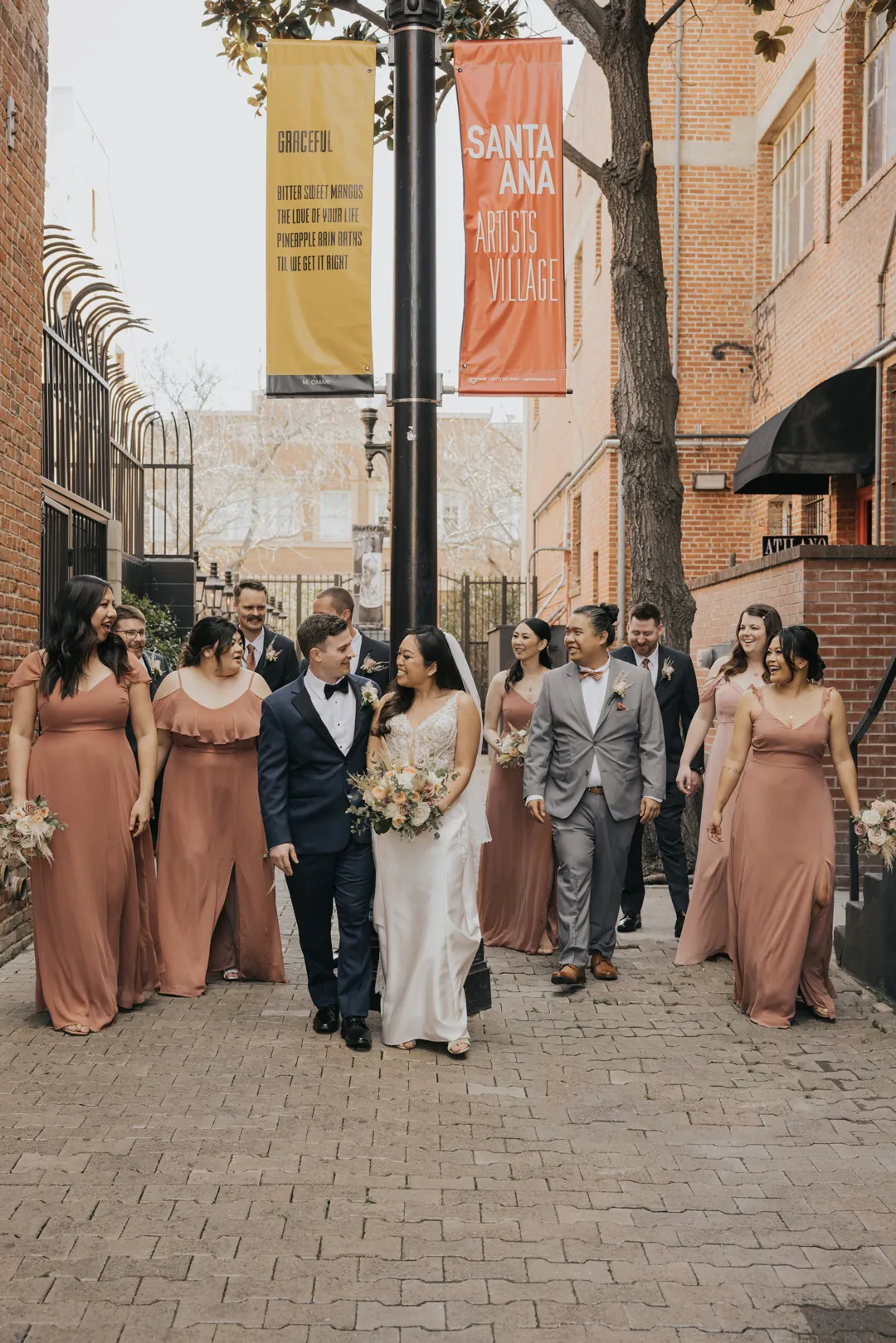 Wedding party pose on a brick paved downtown street.