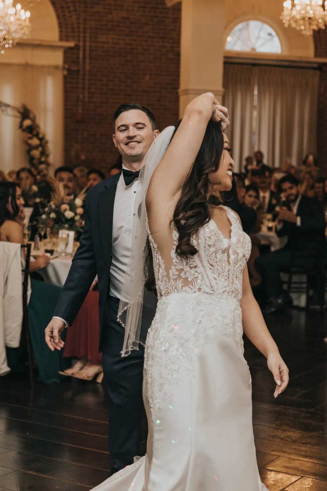Couple celebrate together on the reception floor.