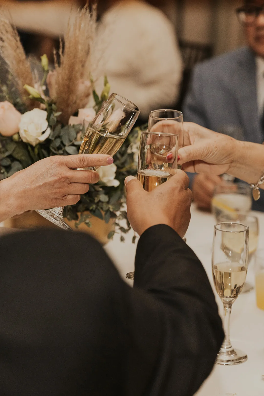 Guests raise glasses together in a toast.