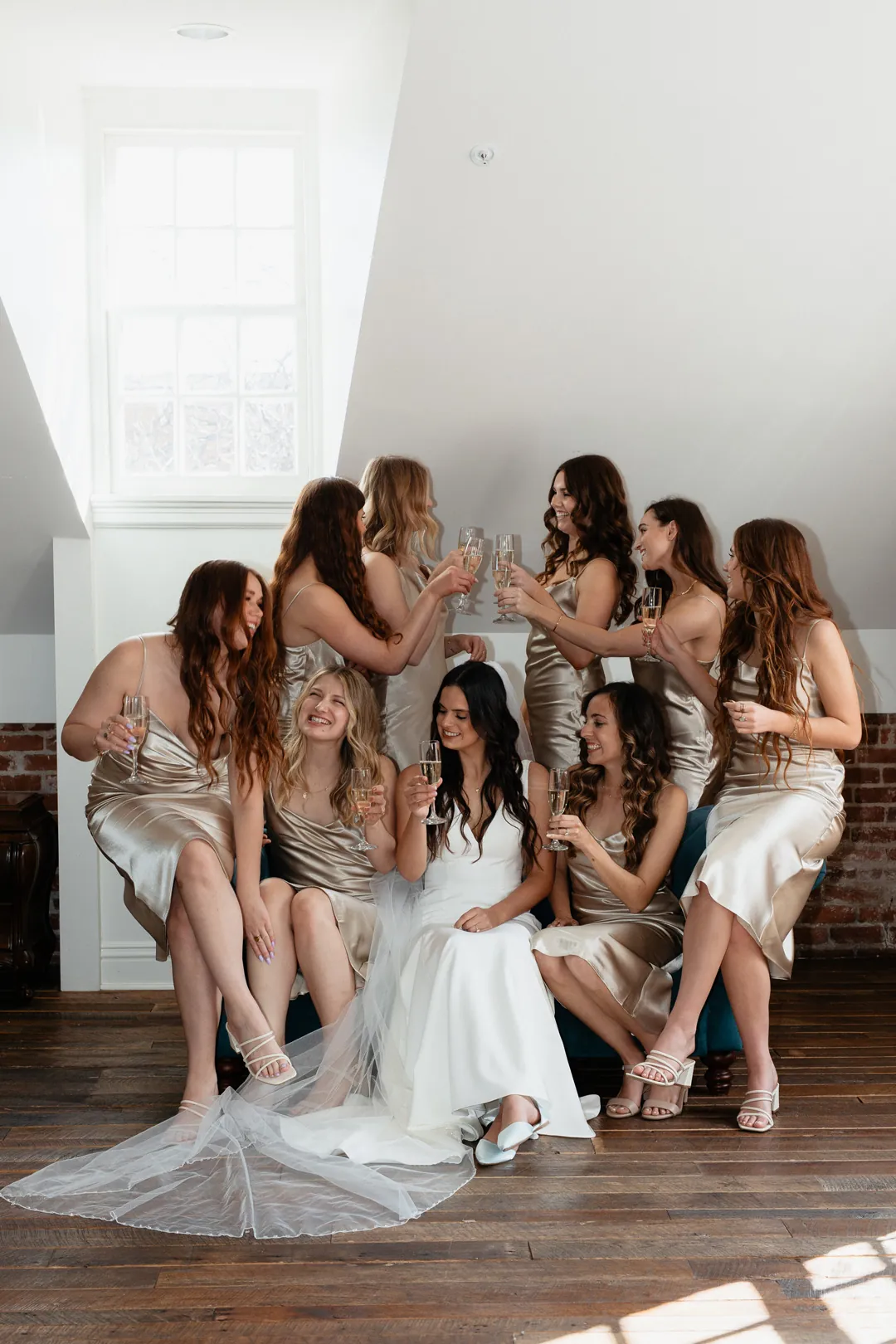 Bride and bridesmaids posing together on a sofa