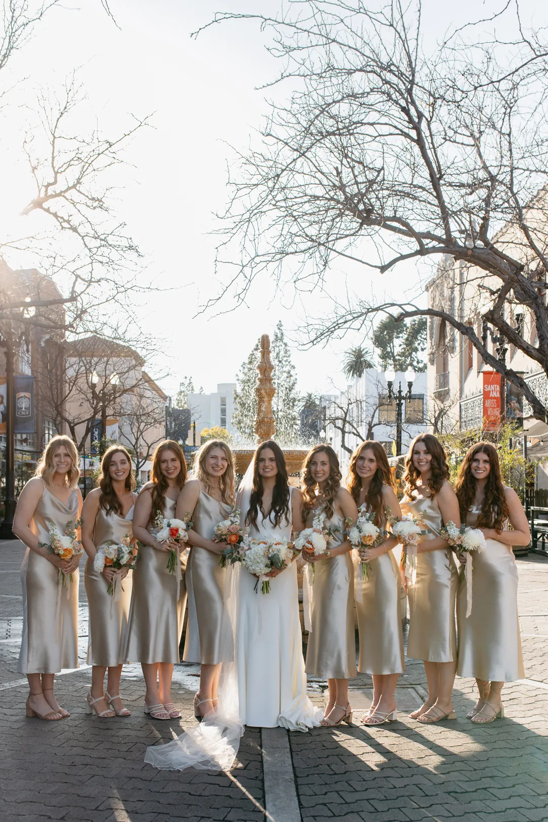 Bride and bridesmaids posing together outdoors