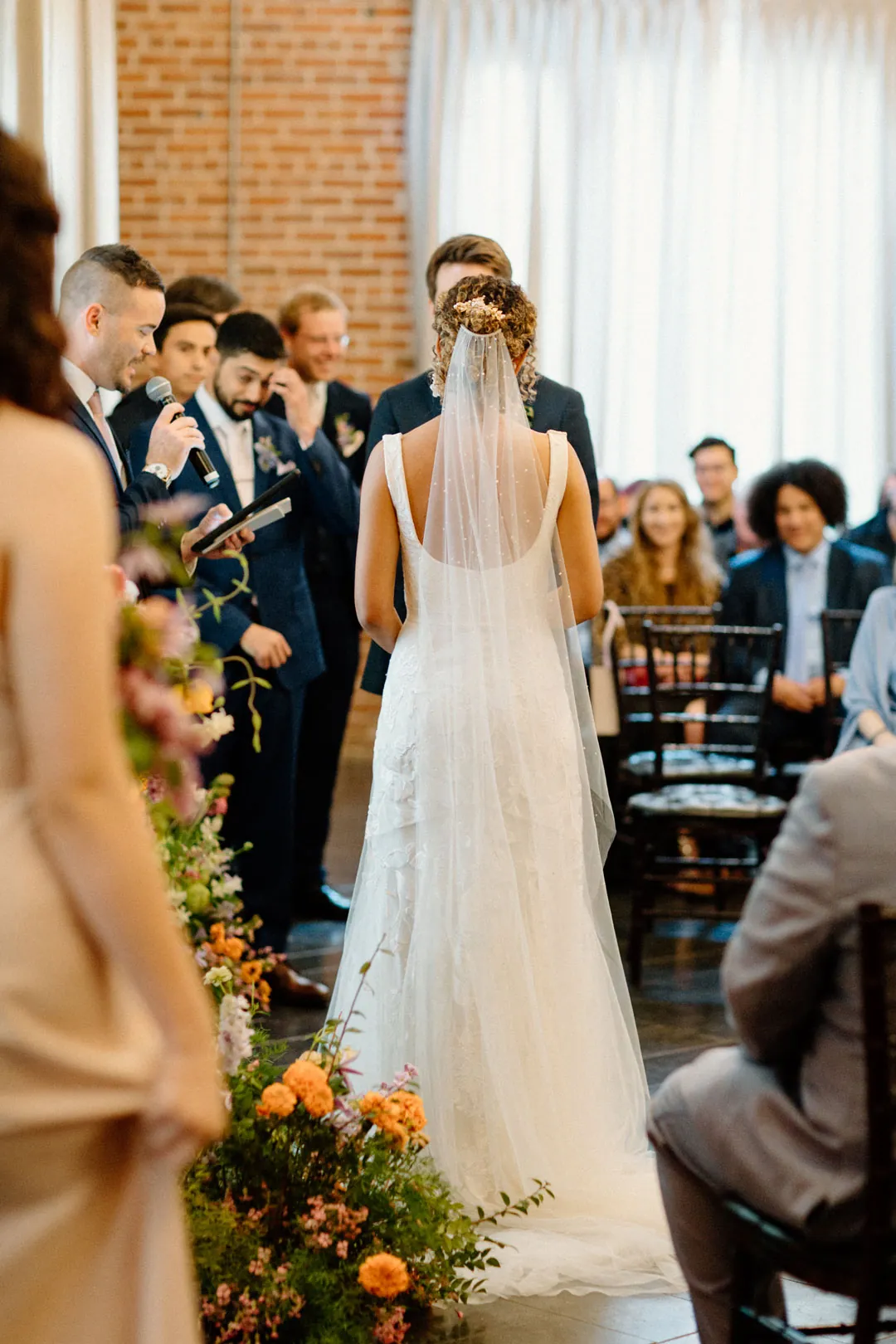 Bride walking down the aisle between seated guests