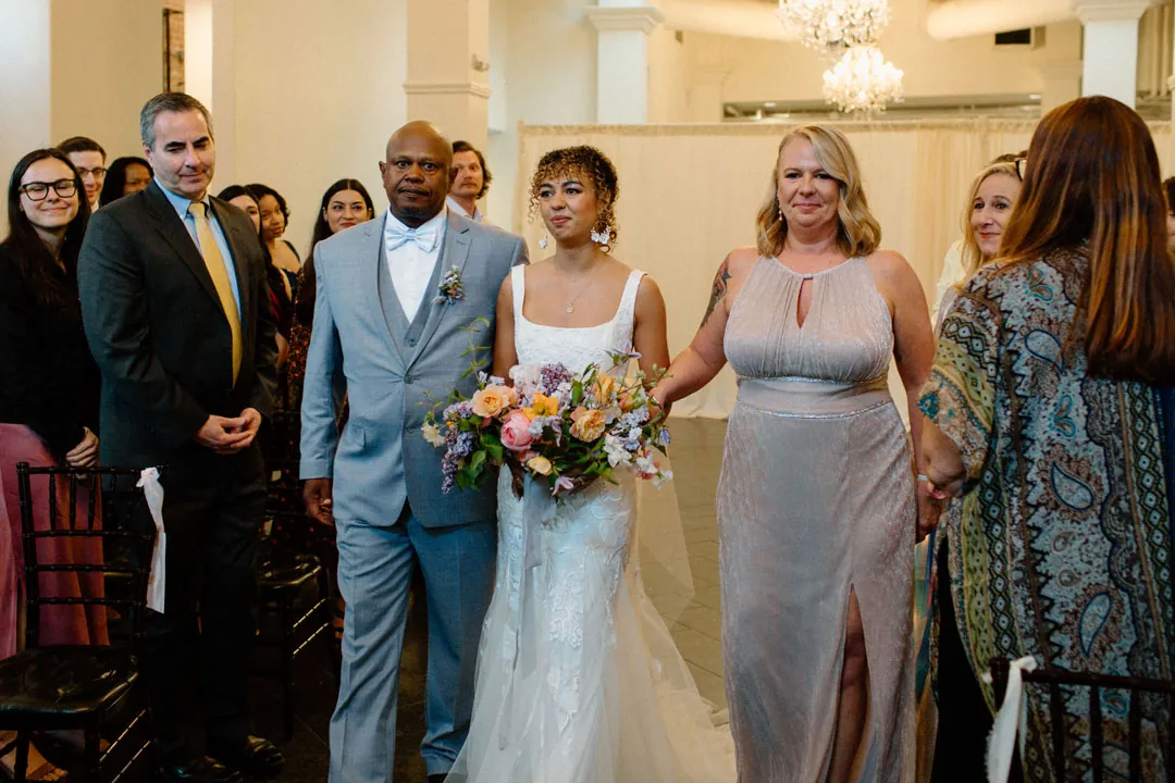 Bride entering the ceremony with two escorts