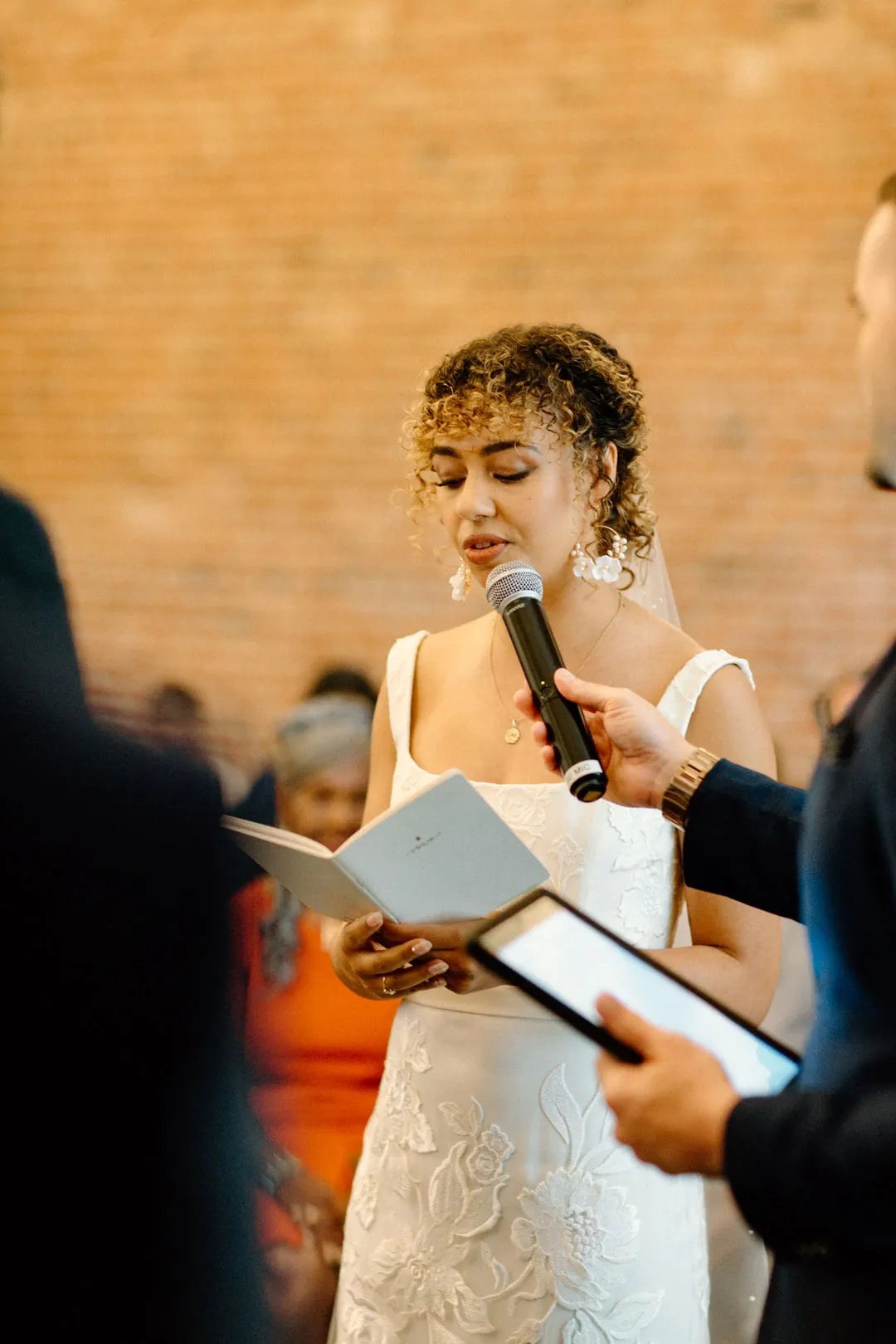 Bride reading her vows from an open book