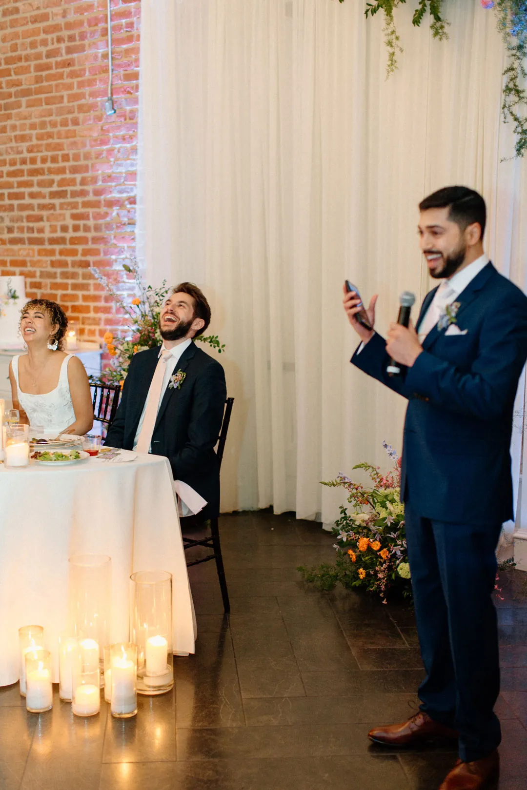 Guest giving a toast beside the couple's table