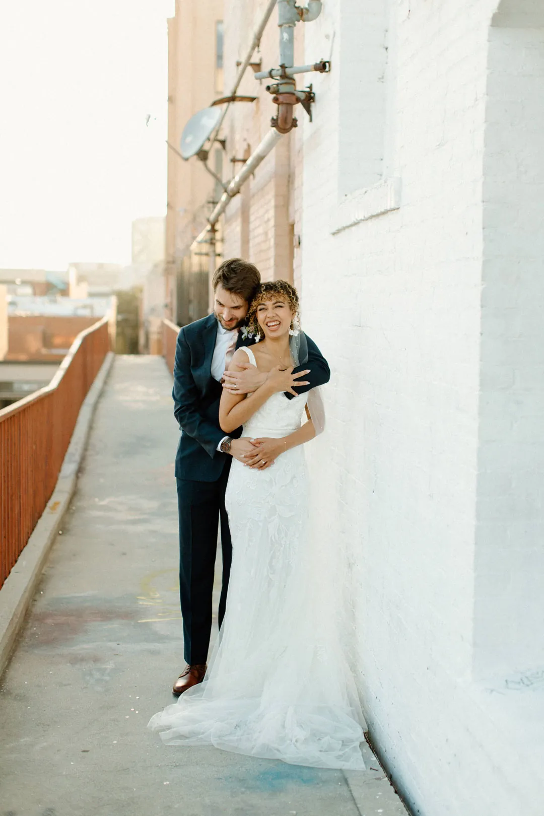 Couple standing together in a narrow outdoor walkway