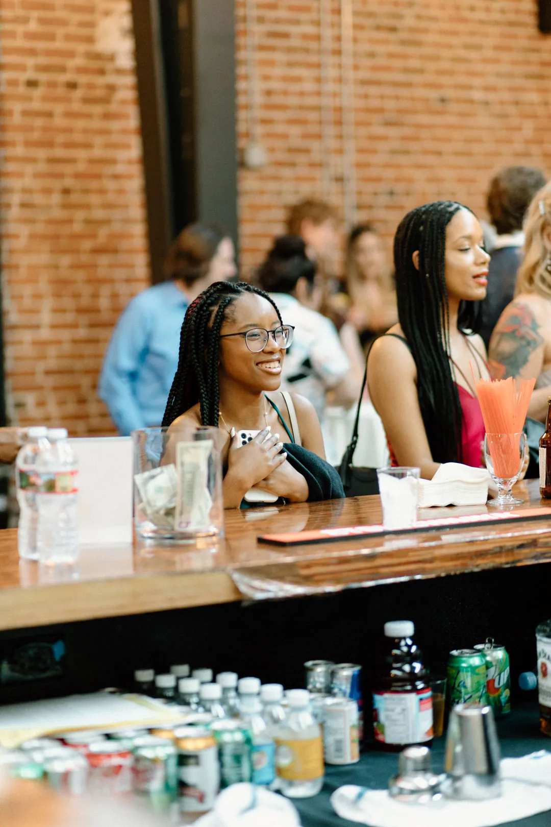 Guests ordering drinks at a wooden bar