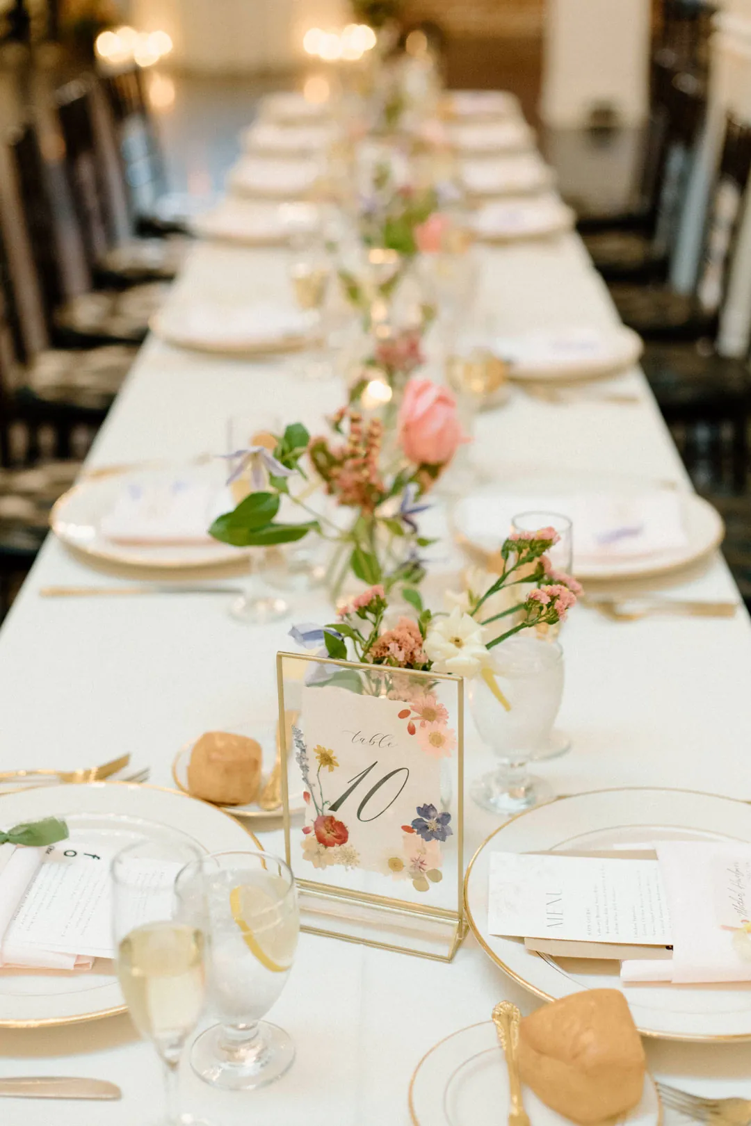 Floral centerpieces lining a long reception table