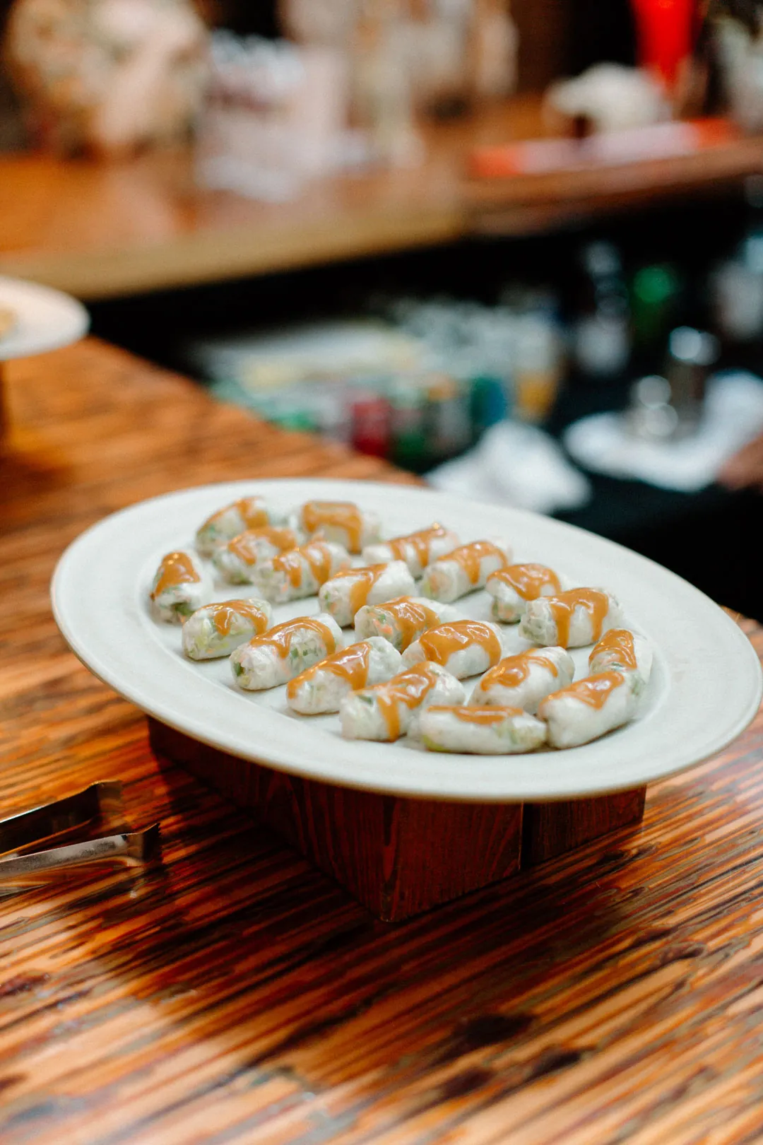 Small appetizers arranged on a white platter at the bar