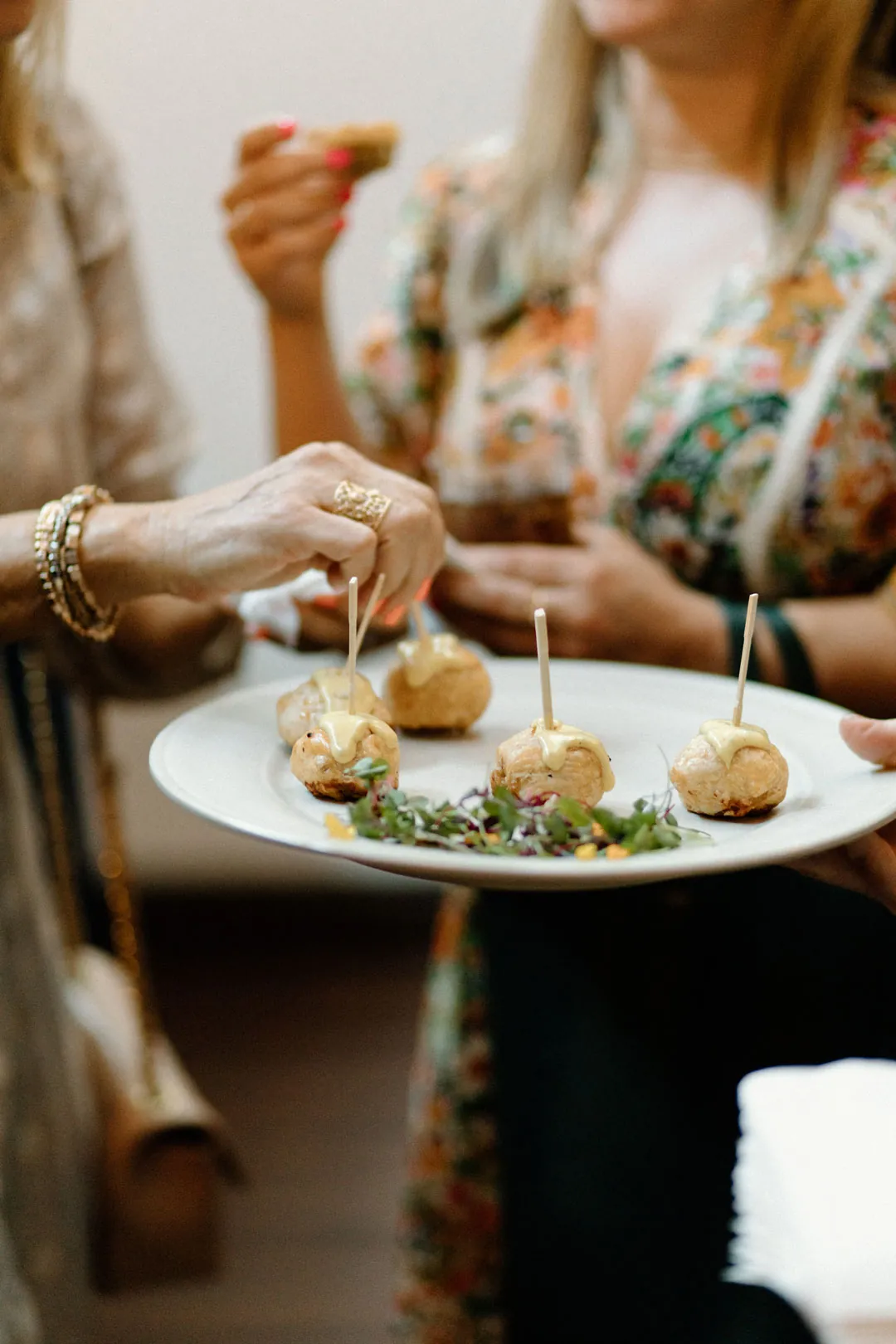 Guest holding a plate of appetizers