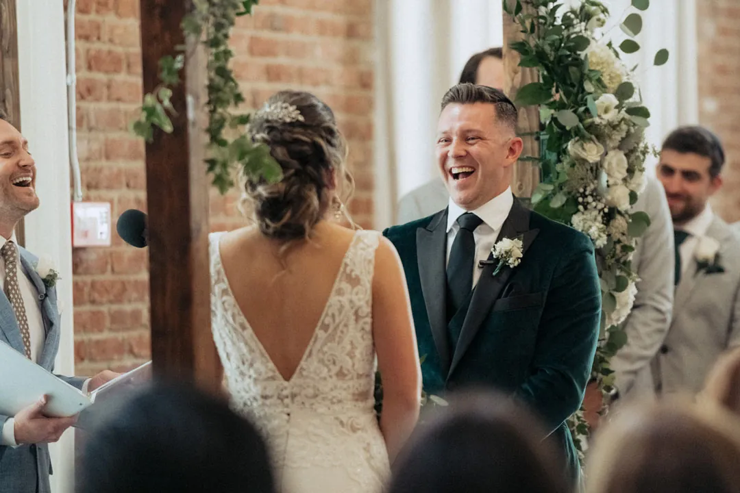 Groom smiling at the bride during the wedding ceremony