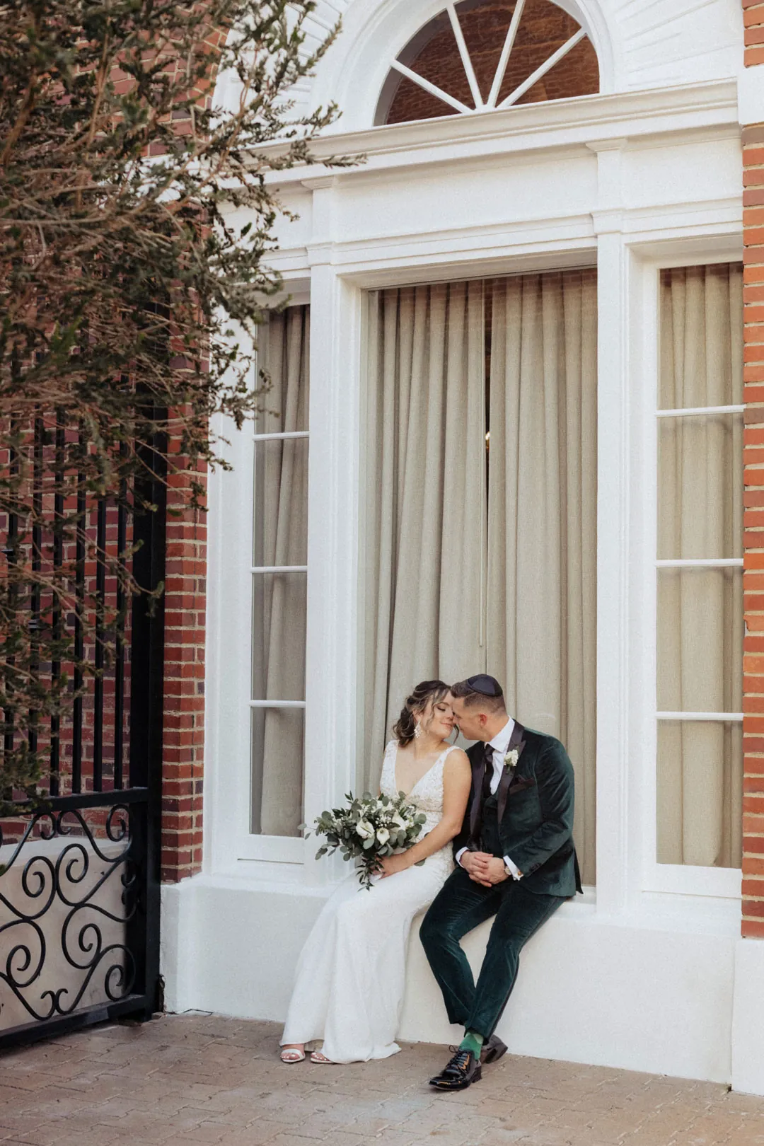 Couple sitting together in a white doorway