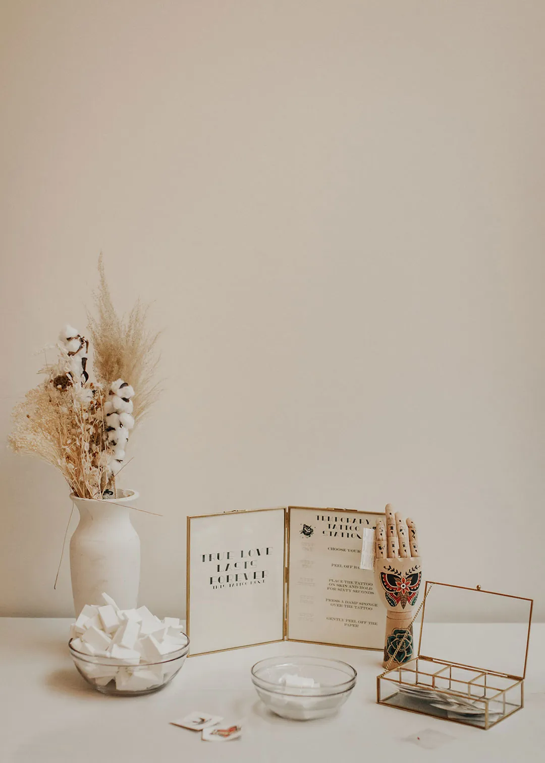 Wedding keepsakes displayed on a white table.