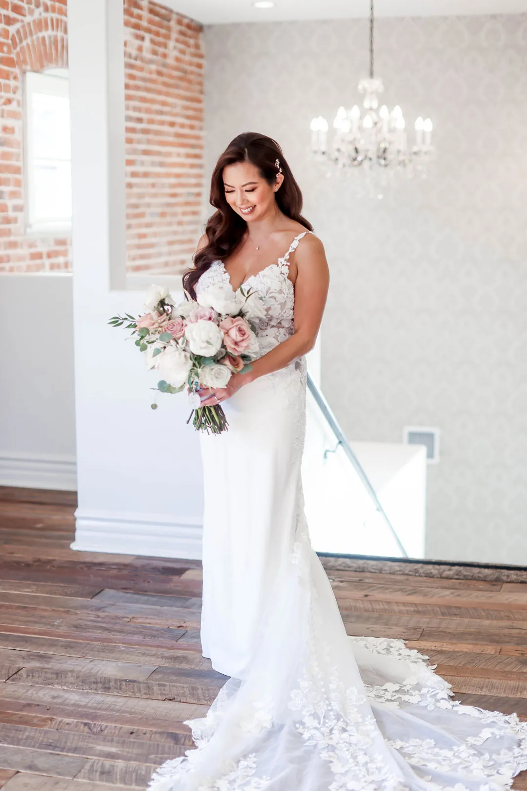 Bride holding her bouquet beside the staircase
