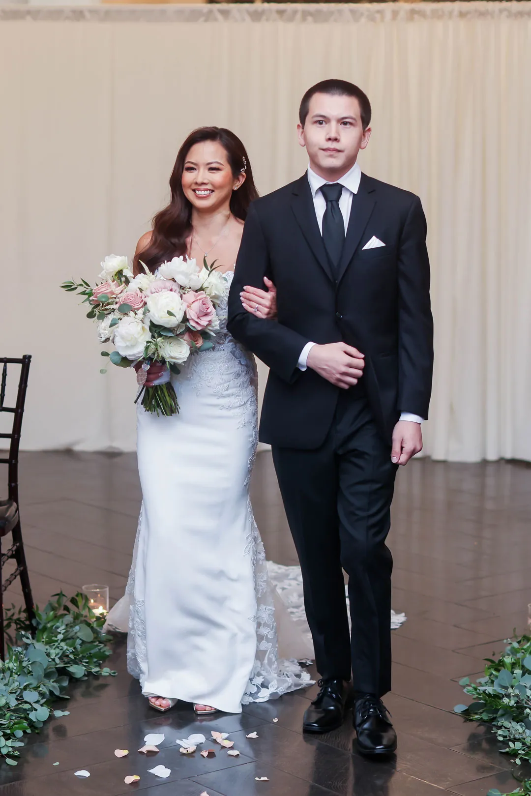 Couple walking into the ceremony together
