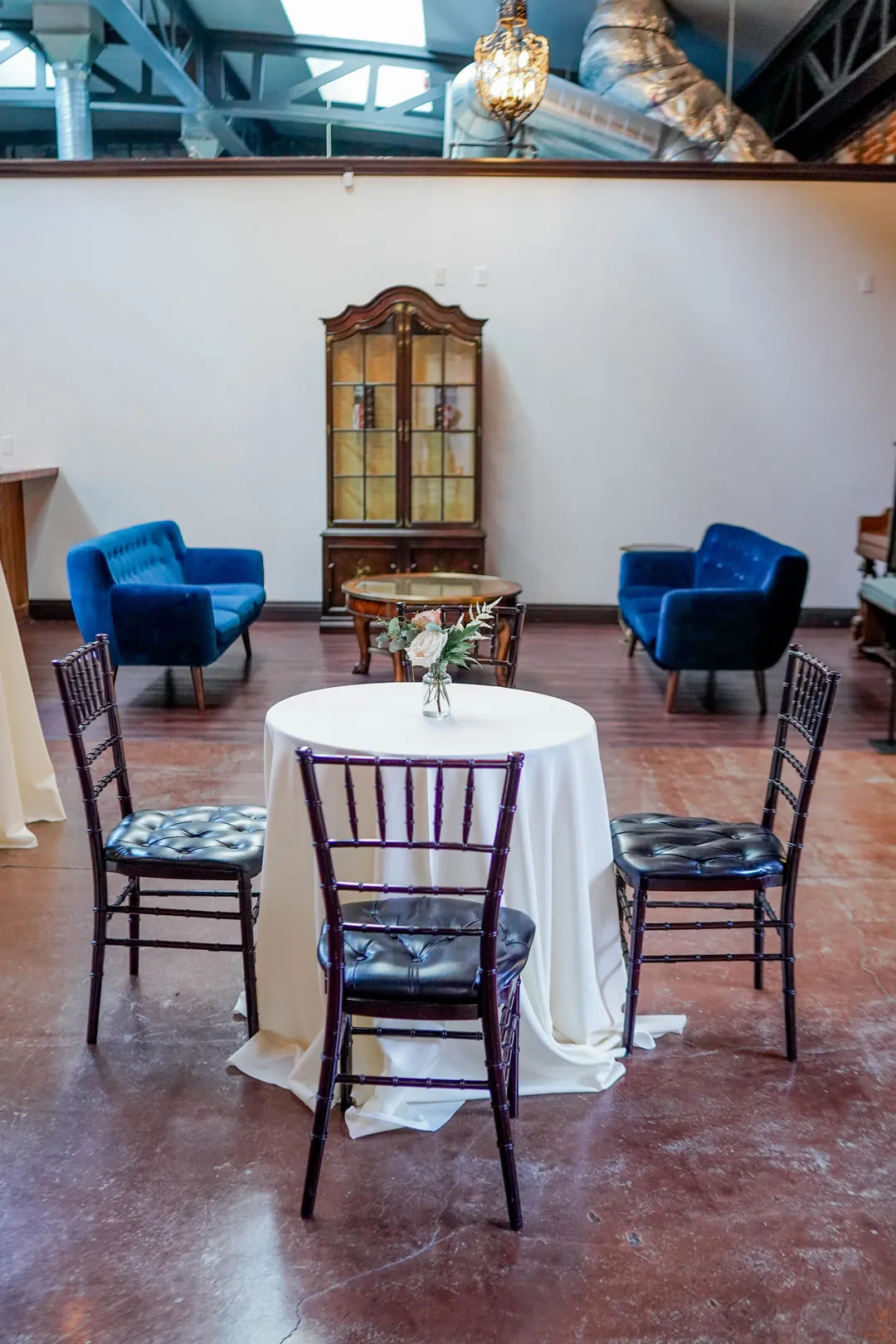 Cocktail tables and lounge chairs in a brick-walled room